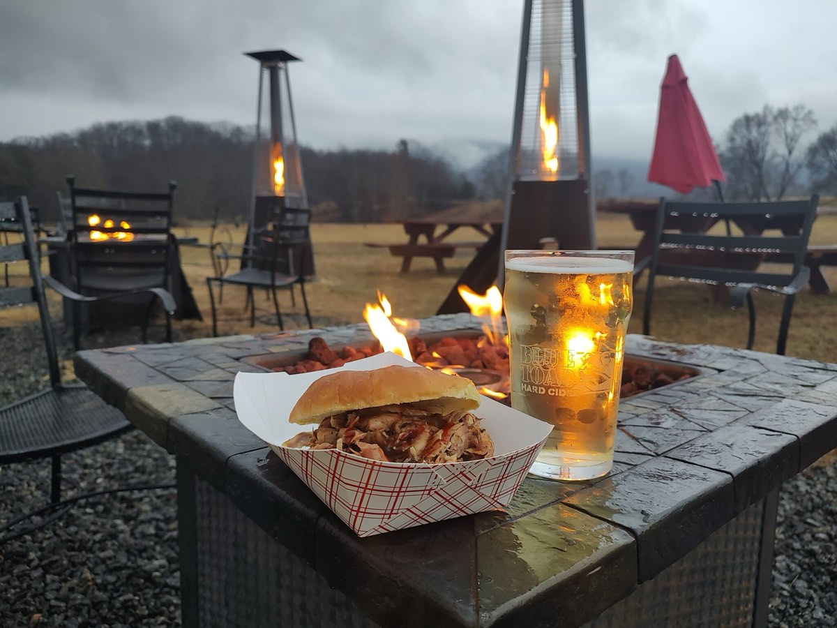 A pulled-pork plate off the rig, with a pint on the table at Blue Toad Cidery